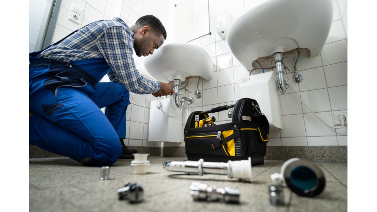 Plumber working on sink installation